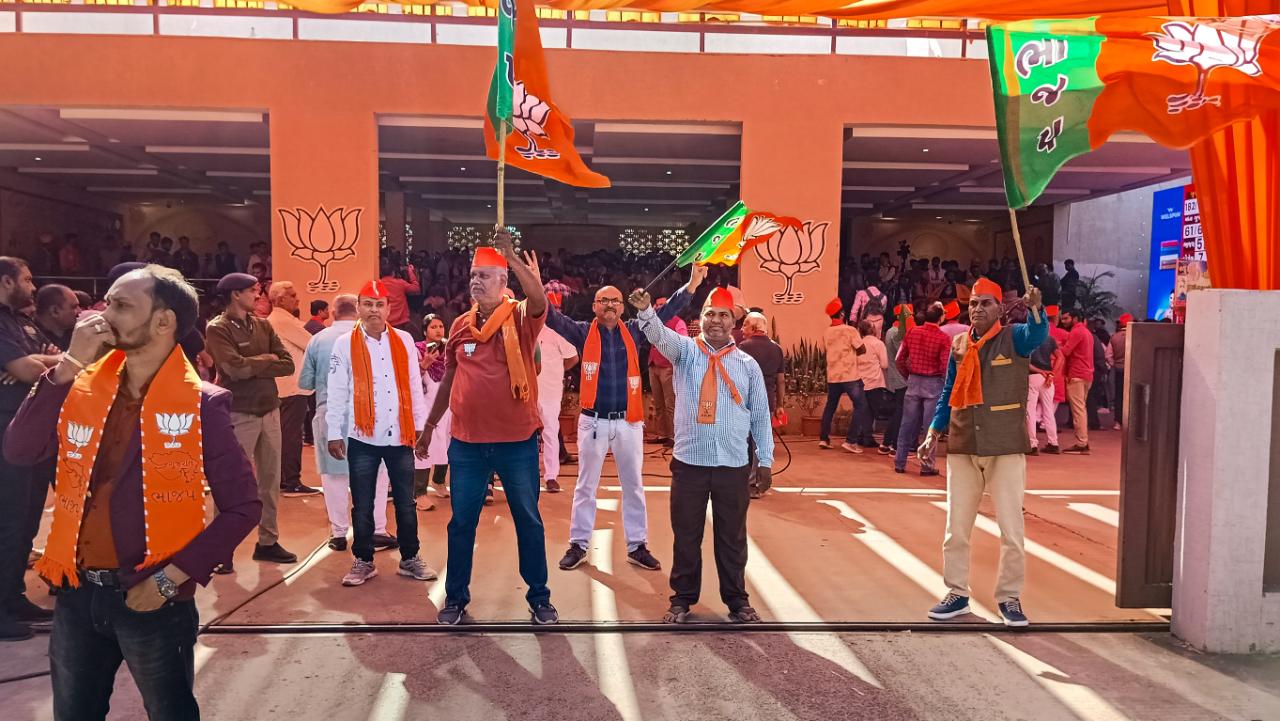 BJP leaders and workers waving the part flag to celebrate the party's decisive lead in Gujarat Assembly elections, at the party headquarters in Gandhinagar